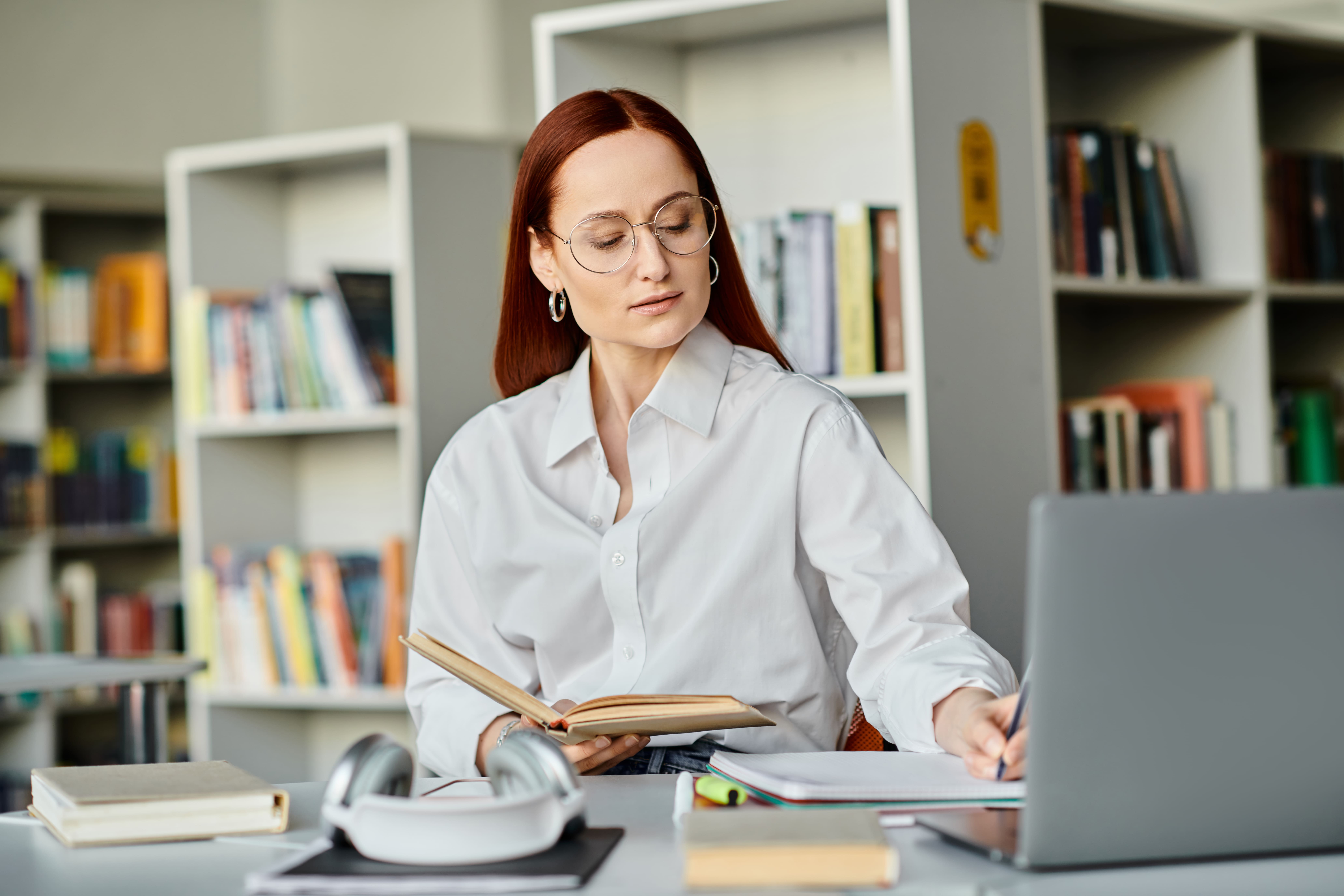 redhead-tutor-engaging-online-learning-in-library-2024-11-16-13-40-58-utc-1